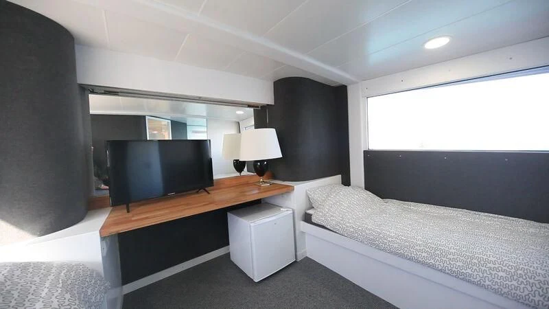 a room with a bed and a tv aboard MARAM Yacht for Sale