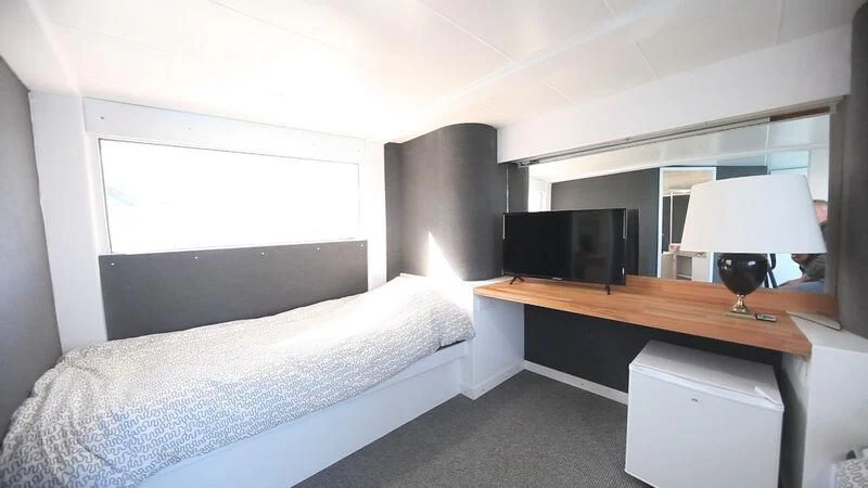 a bedroom with a lamp and a bed aboard MARAM Yacht for Sale