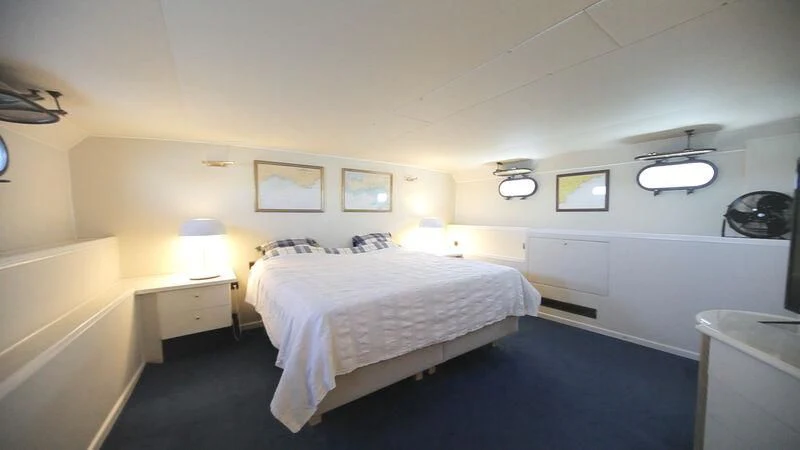 a bedroom with a bed and a desk aboard MARAM Yacht for Sale
