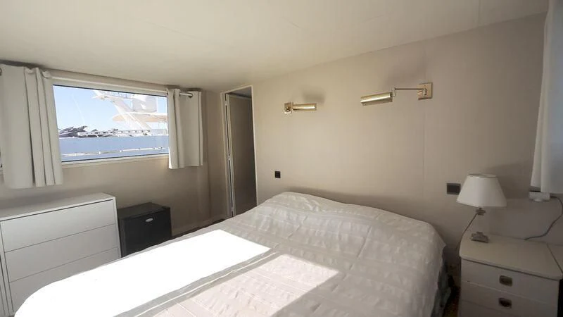a bedroom with a large bed aboard MARAM Yacht for Sale