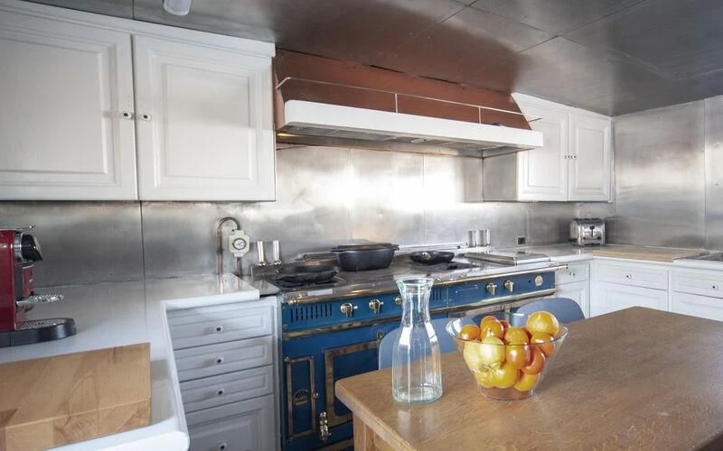 a kitchen with white cabinets aboard MARAM Yacht for Sale