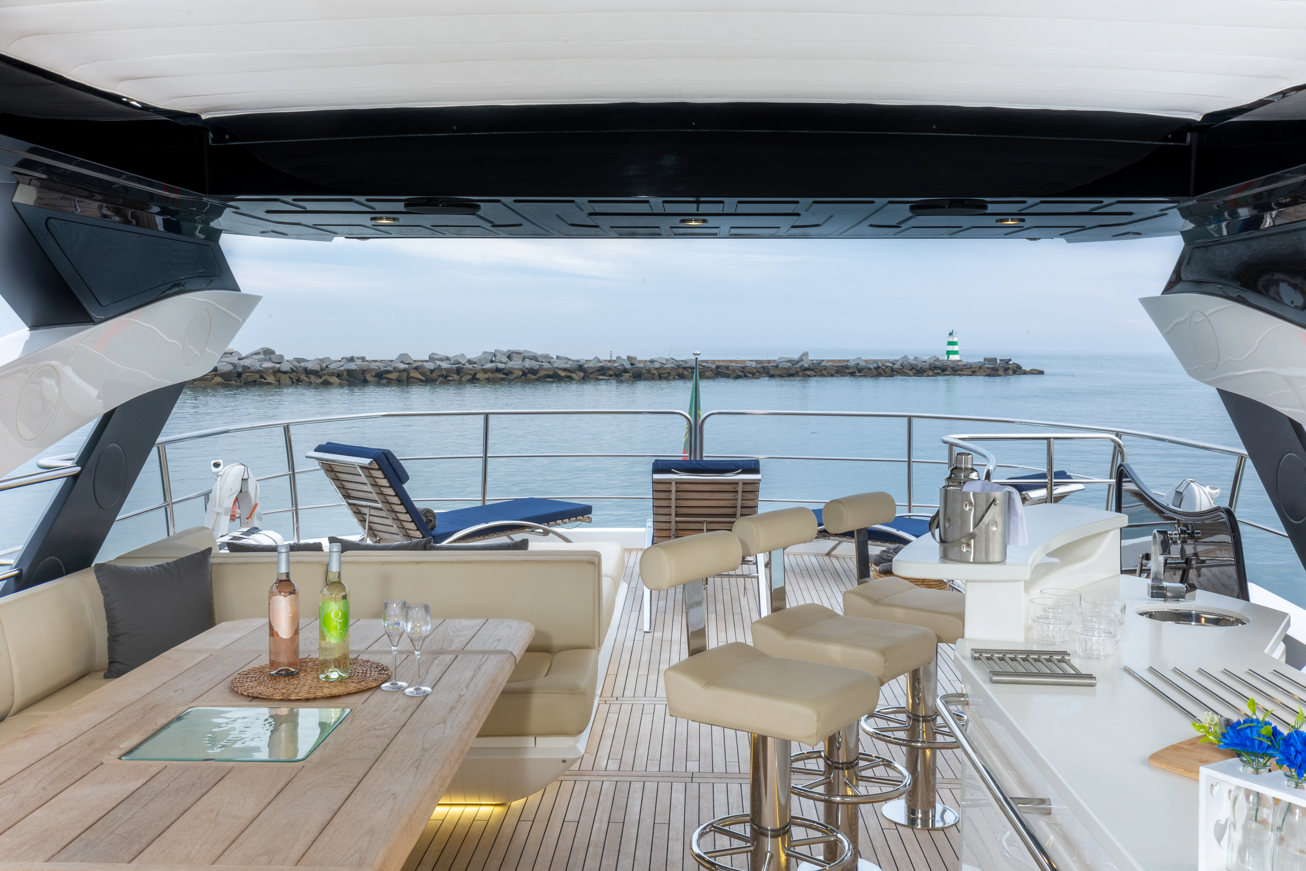 a room with a table chairs and a large body of water aboard STARDUST OF MARY Yacht for Sale