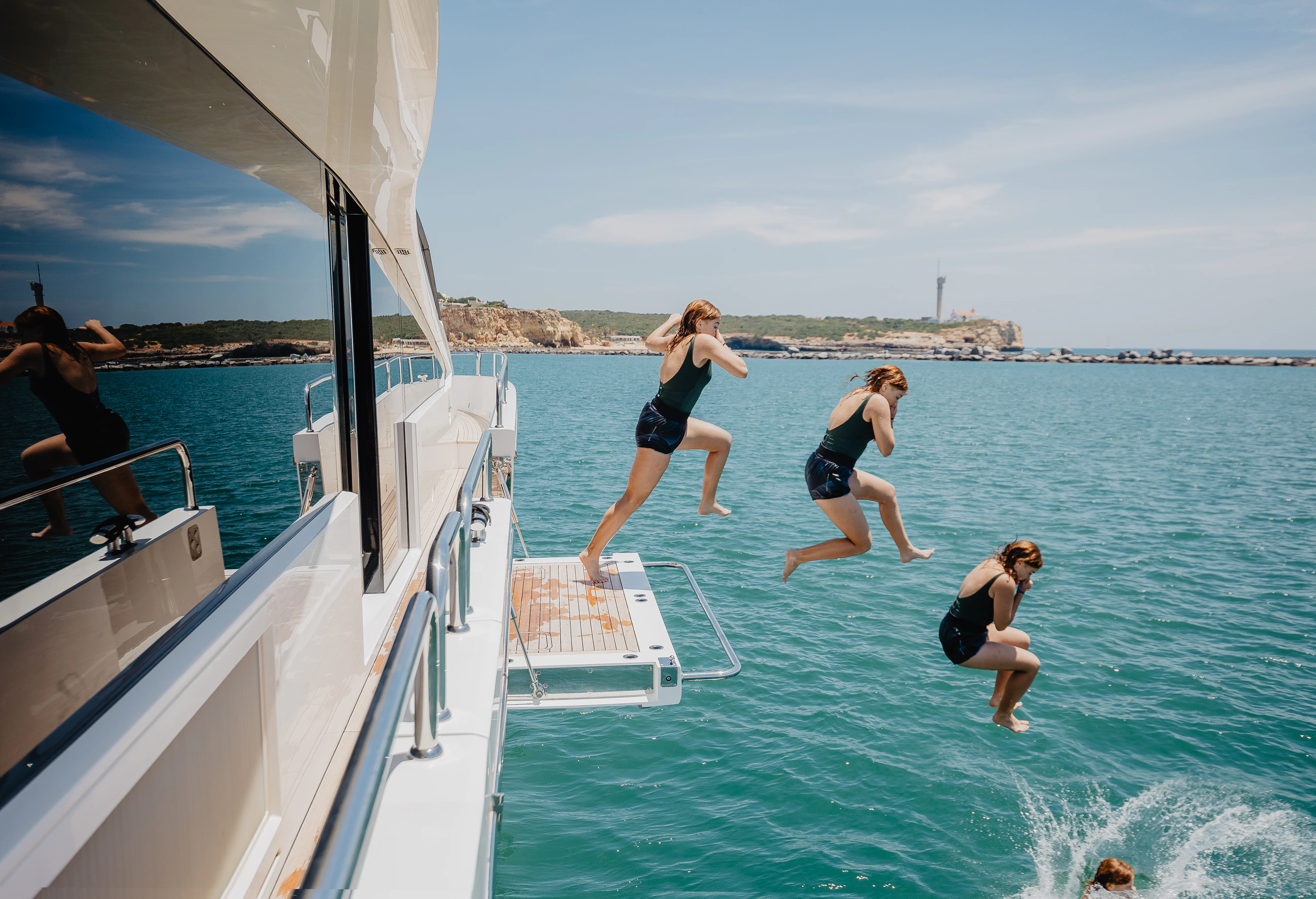 a group of people jumping into a body of water aboard STARDUST OF MARY Yacht for Sale