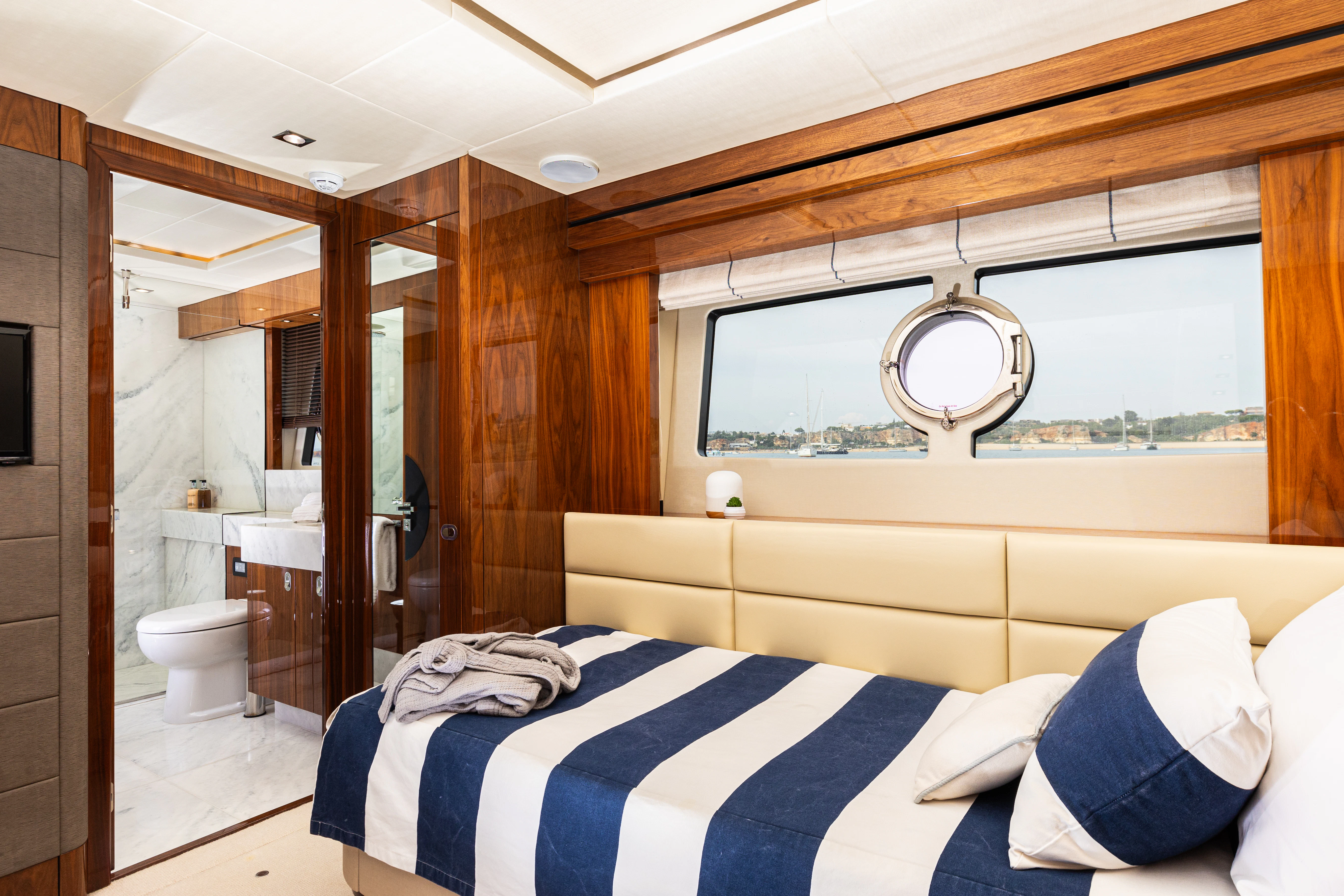 a room with a bed and a mirror aboard STARDUST OF MARY Yacht for Sale