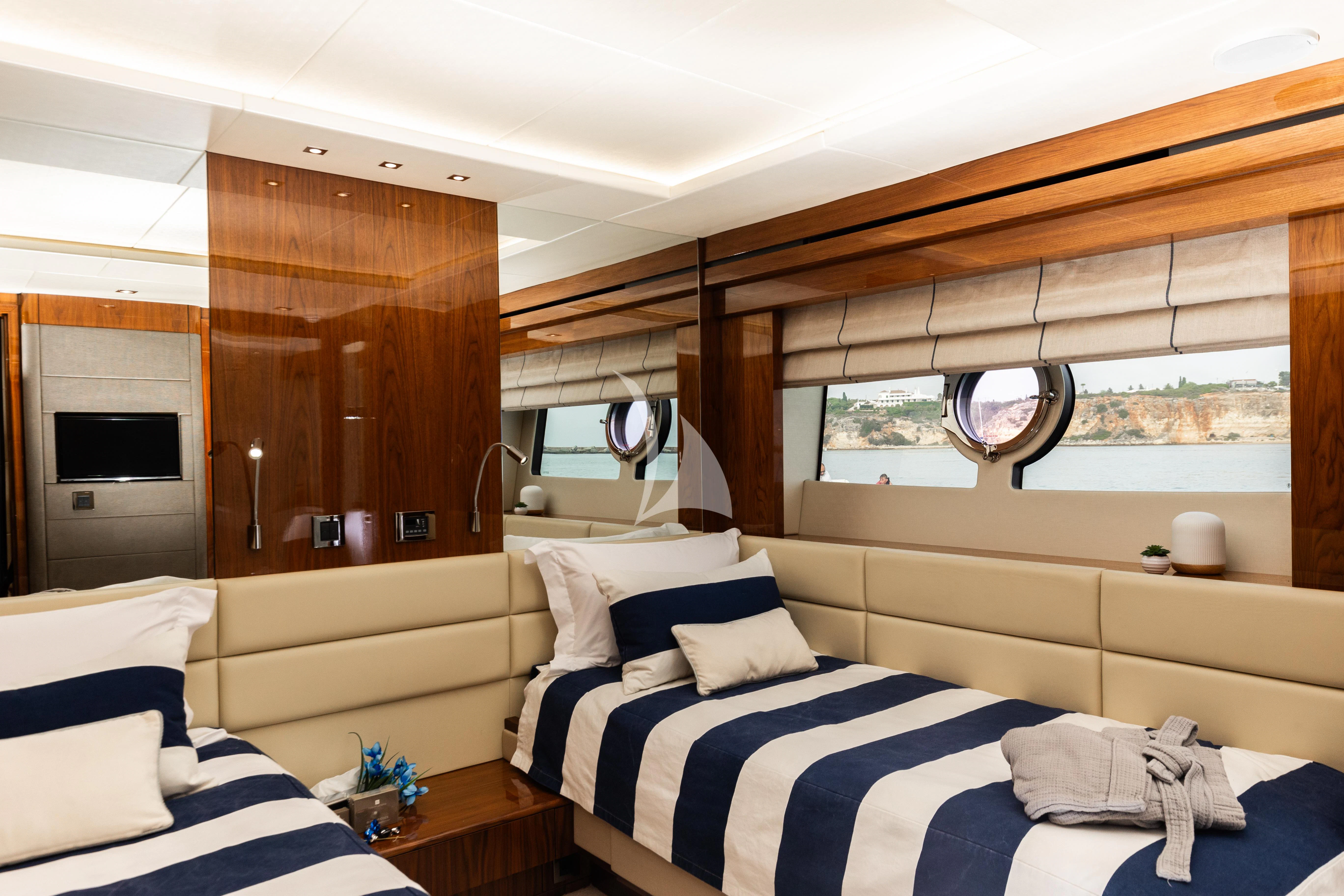 a bedroom with a bed and a wood cabinet aboard STARDUST OF MARY Yacht for Sale