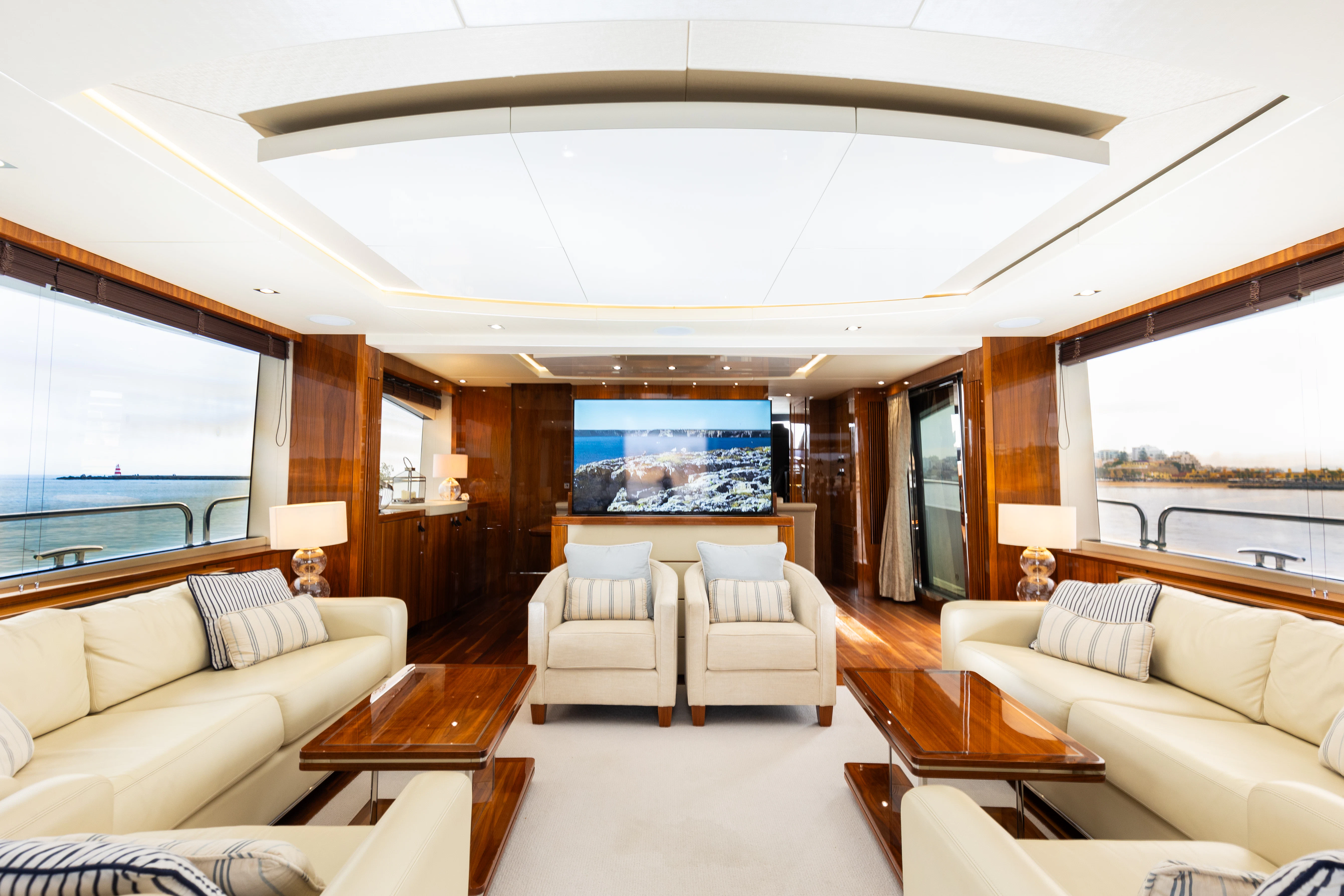 a living room with a large screen aboard STARDUST OF MARY Yacht for Sale