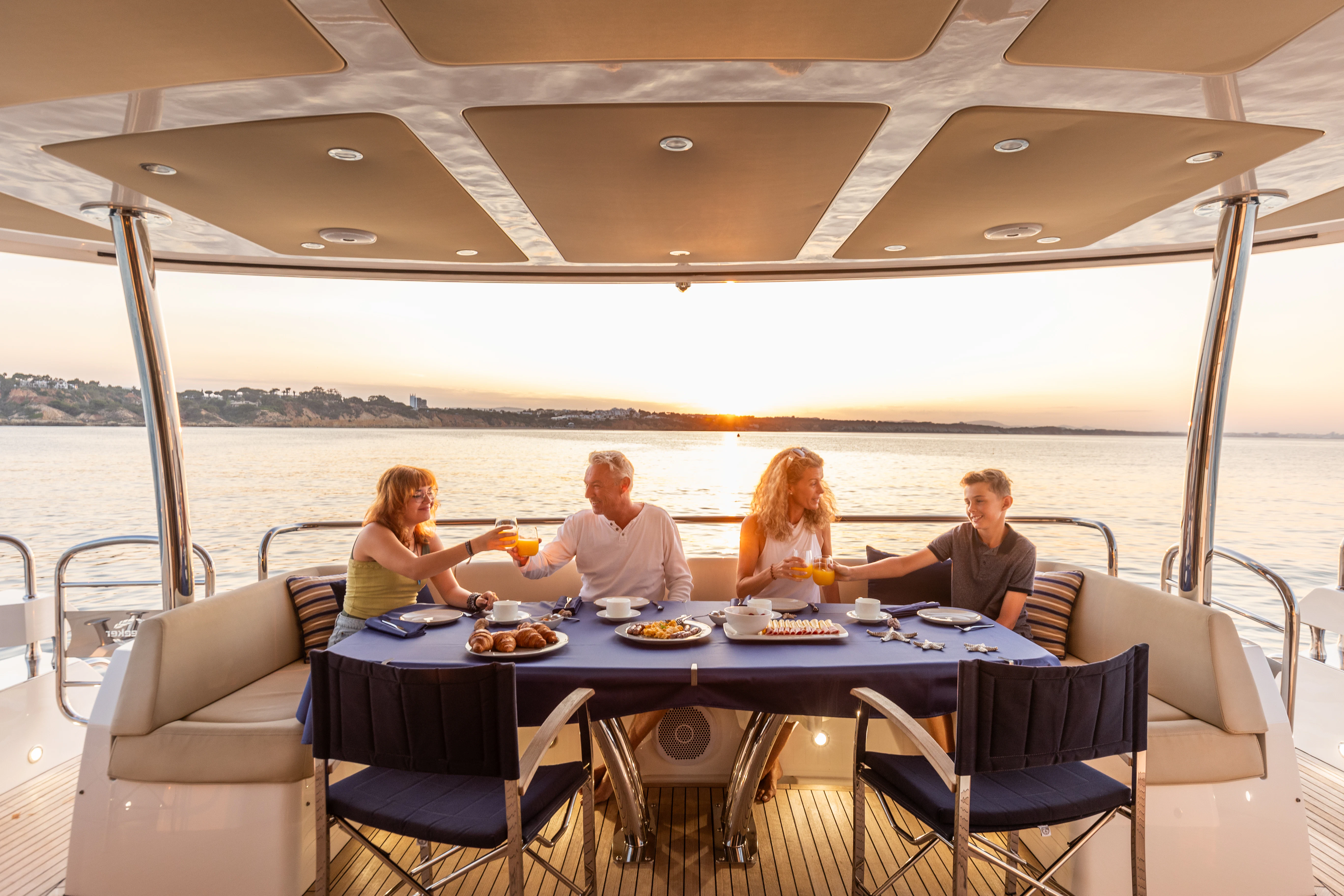 a group of people sitting at a table on a boat aboard STARDUST OF MARY Yacht for Sale