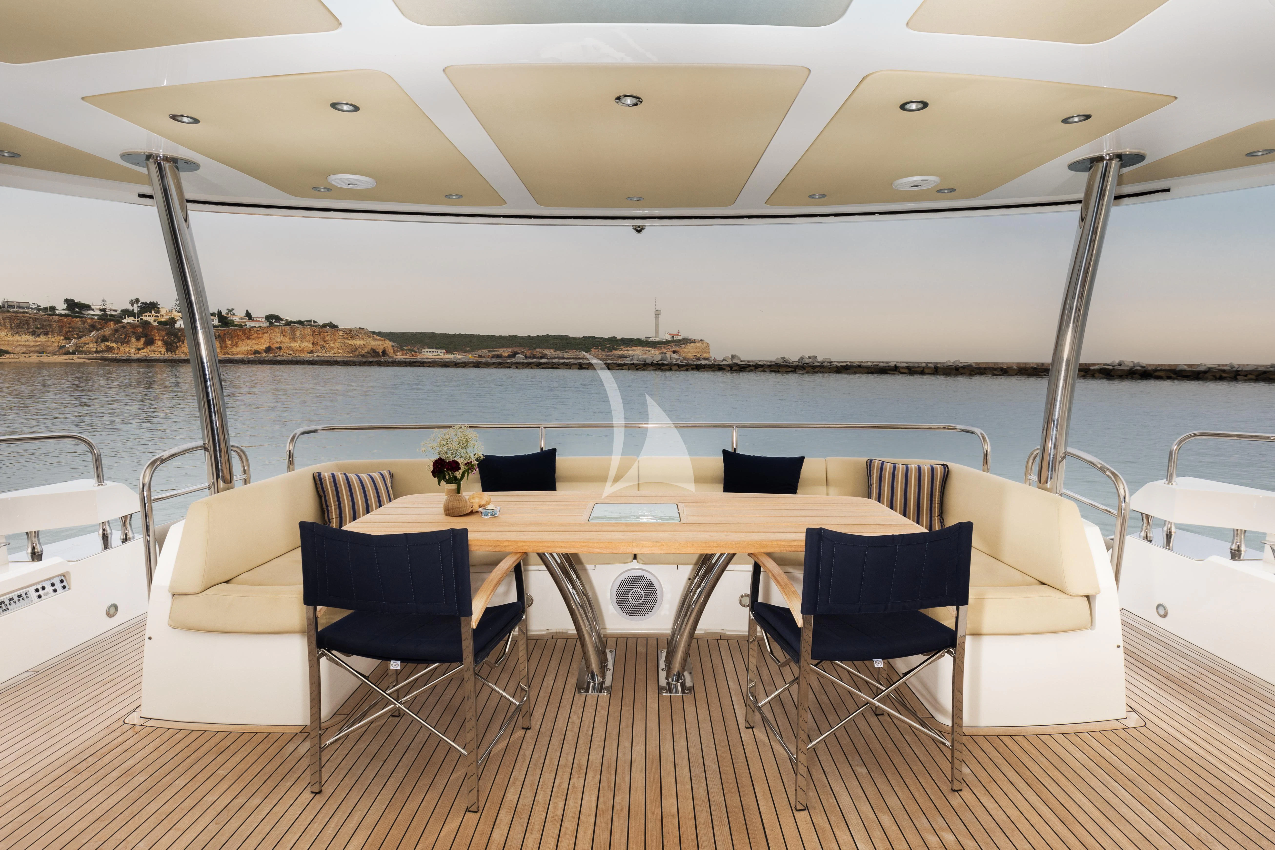 a table and chairs on a deck aboard STARDUST OF MARY Yacht for Sale