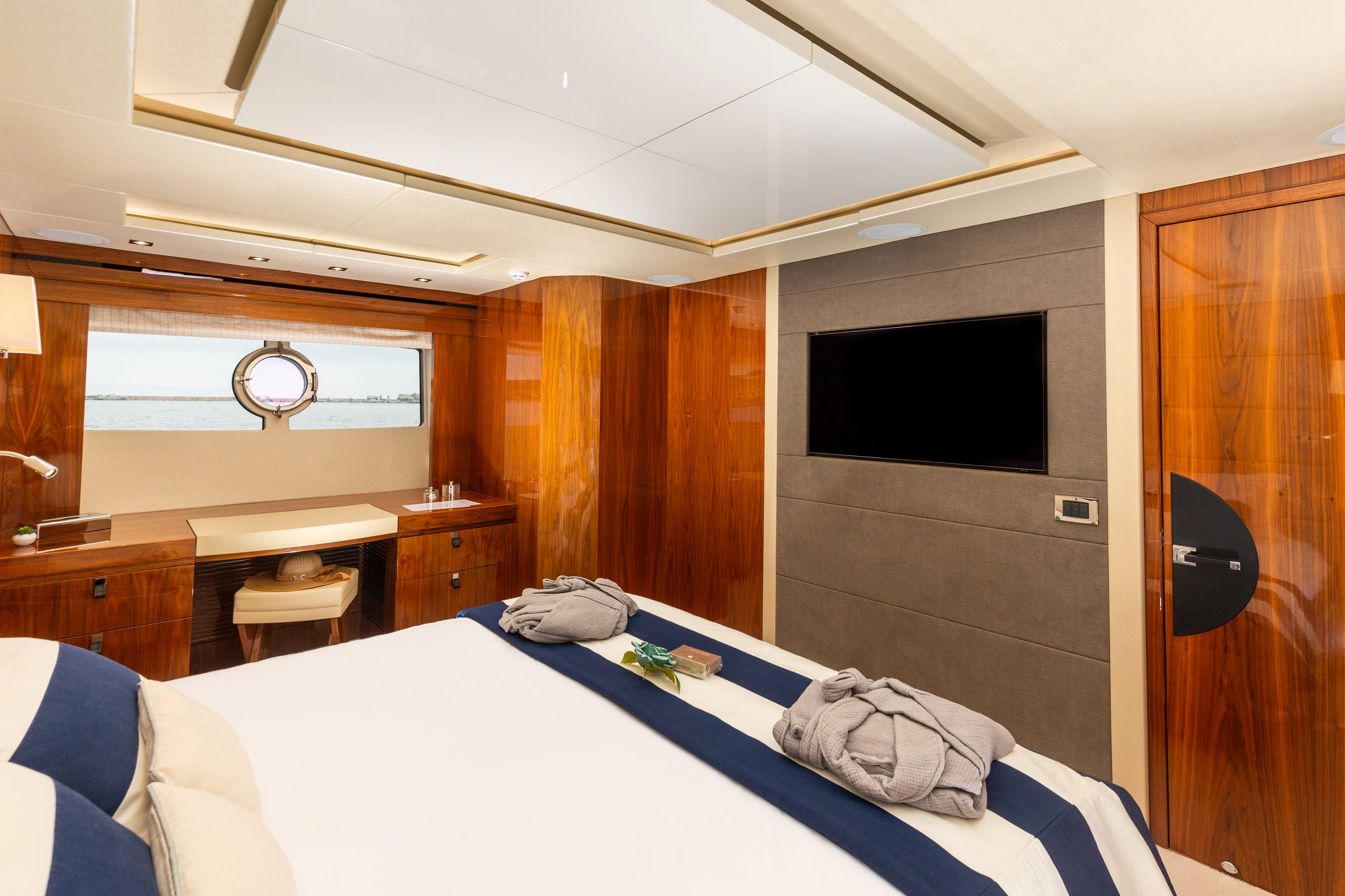 a bedroom with a bed and tv aboard STARDUST OF MARY Yacht for Sale