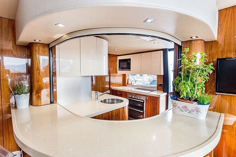 a kitchen with a large island aboard STARDUST OF MARY Yacht for Sale