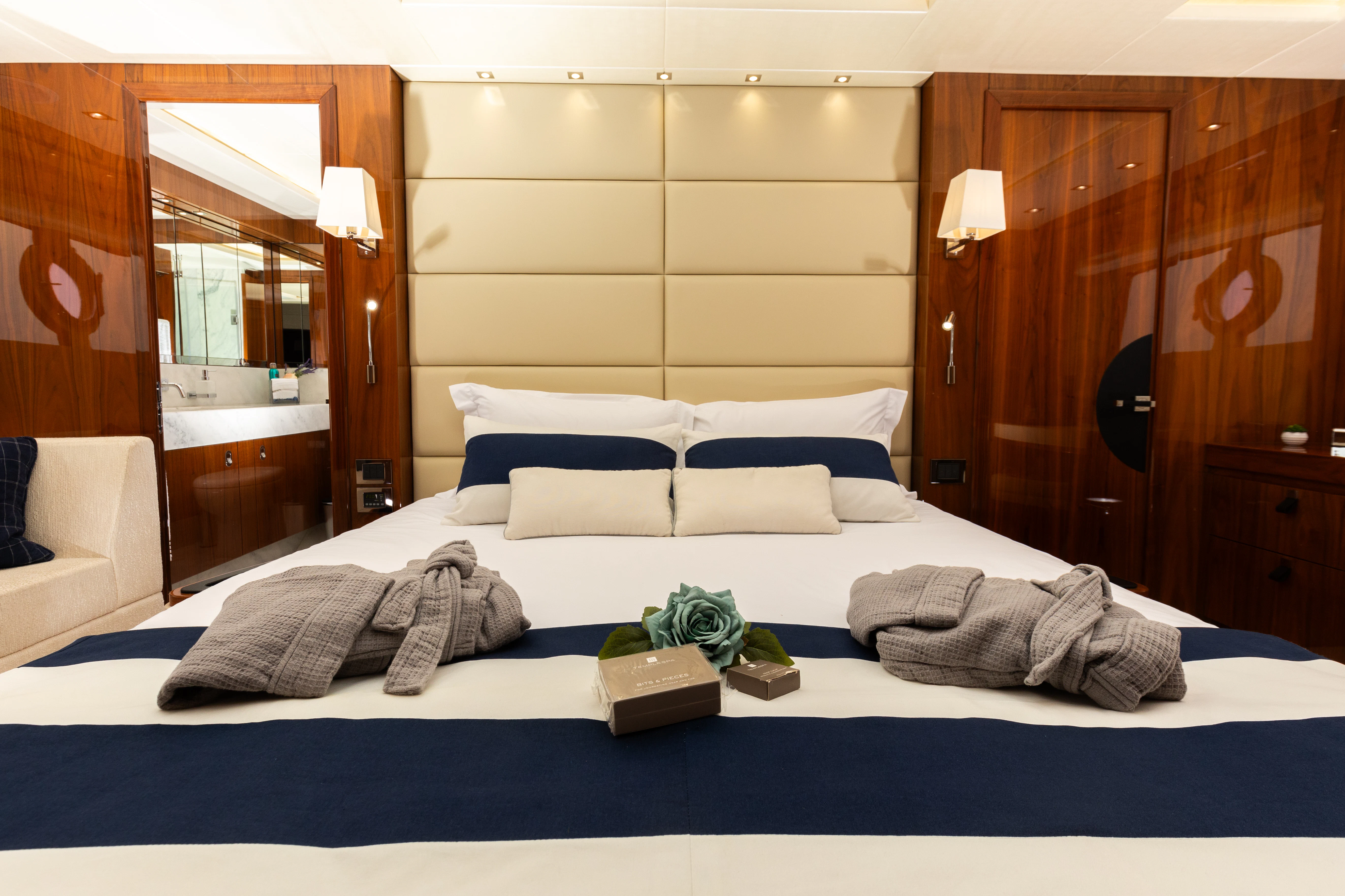 a bed with a blue comforter and pillows aboard STARDUST OF MARY Yacht for Sale