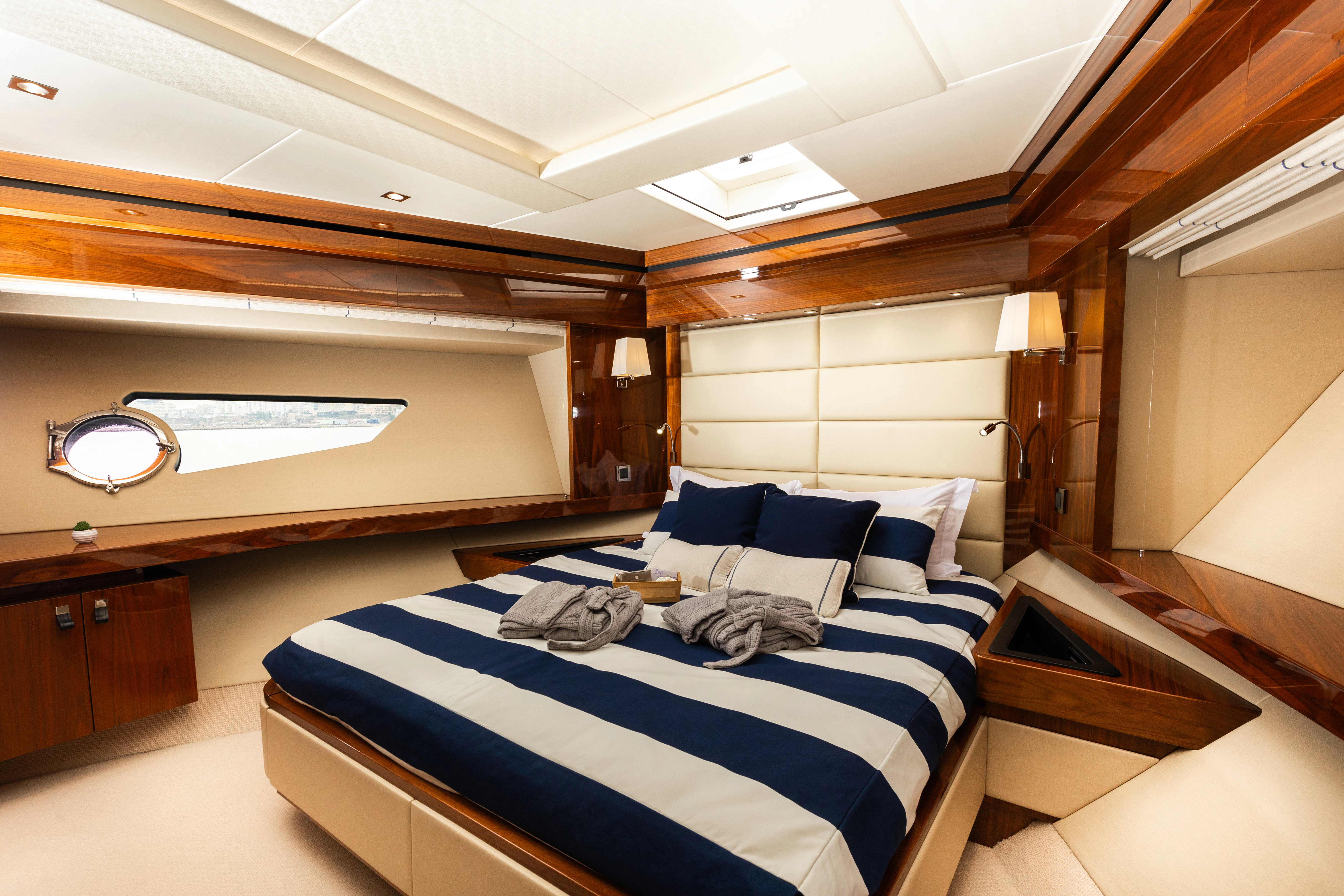 a room with a bed and a desk aboard STARDUST OF MARY Yacht for Sale