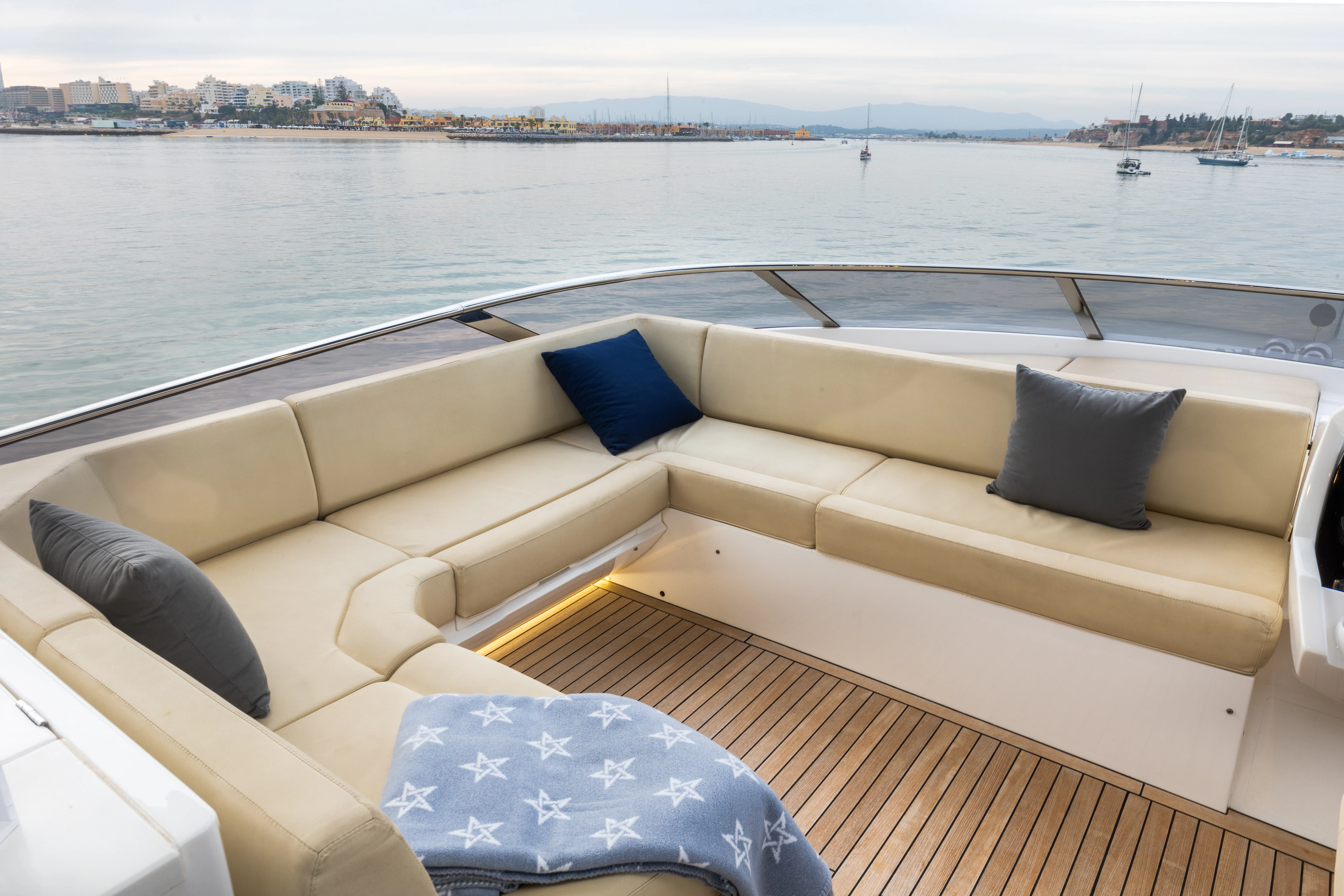 a couch on a deck overlooking a body of water aboard STARDUST OF MARY Yacht for Sale