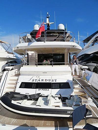 a large white boat with a red stripe on the front aboard STARDUST OF MARY Yacht for Sale