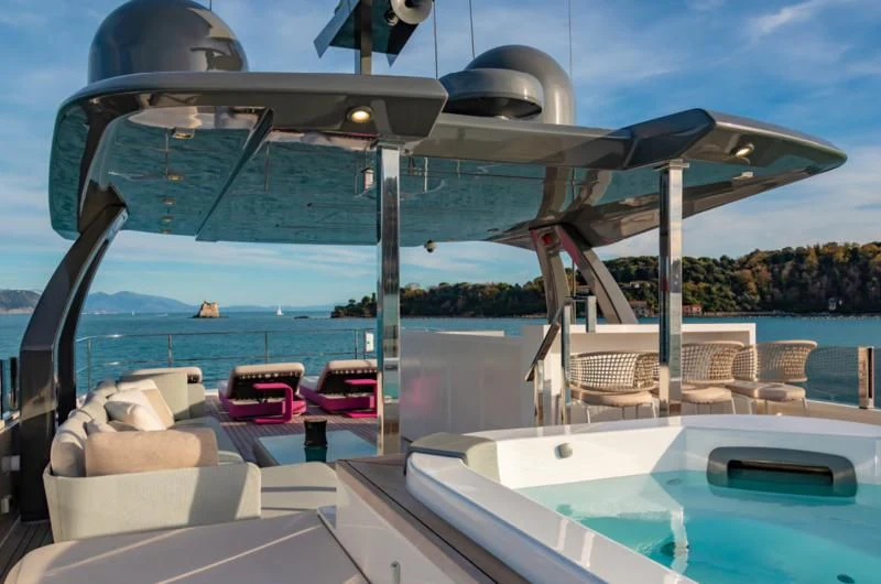 a large pool with a deck and chairs and a view of the water aboard FRANGELO Yacht for Sale