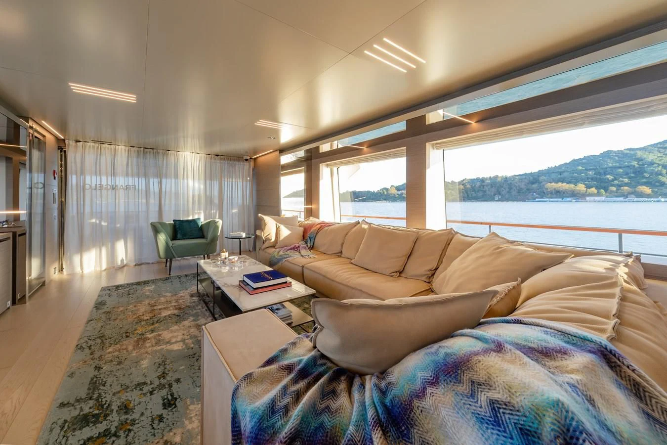 a living room with a large window aboard FRANGELO Yacht for Sale