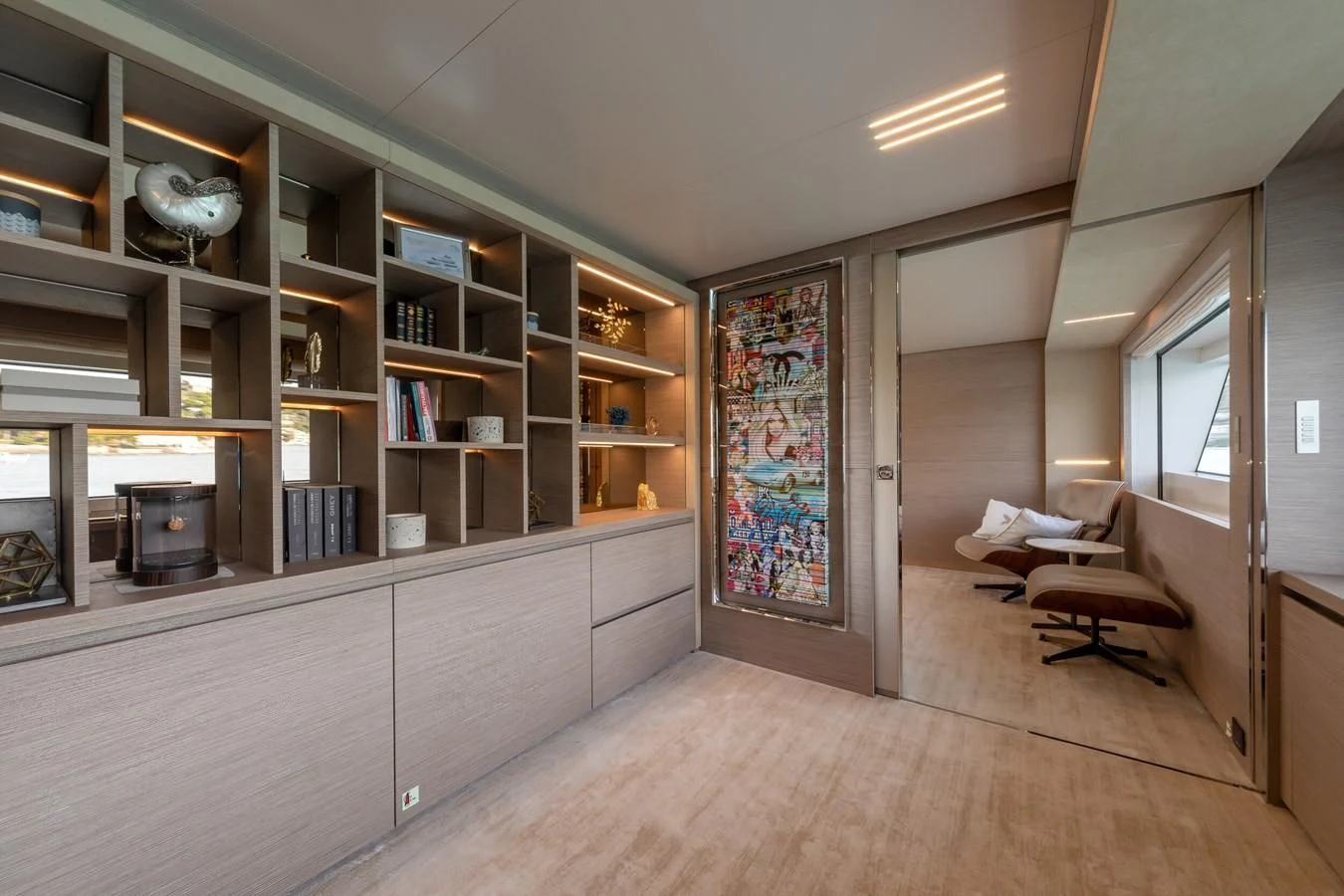 a room with a wood floor and a bookshelf aboard FRANGELO Yacht for Sale