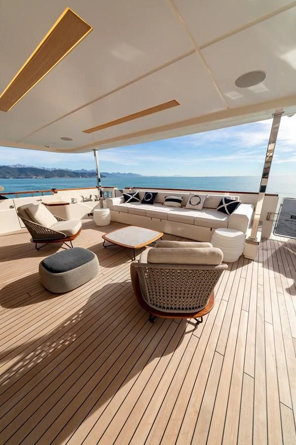 a room with a deck and a view of the ocean aboard FRANGELO Yacht for Sale