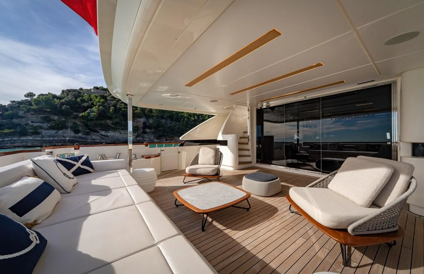 a room with a table chairs and a tv aboard FRANGELO Yacht for Sale