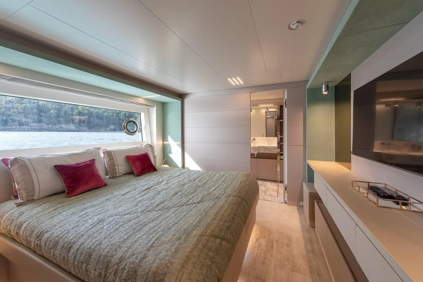 a bedroom with a bed and a desk aboard FRANGELO Yacht for Sale