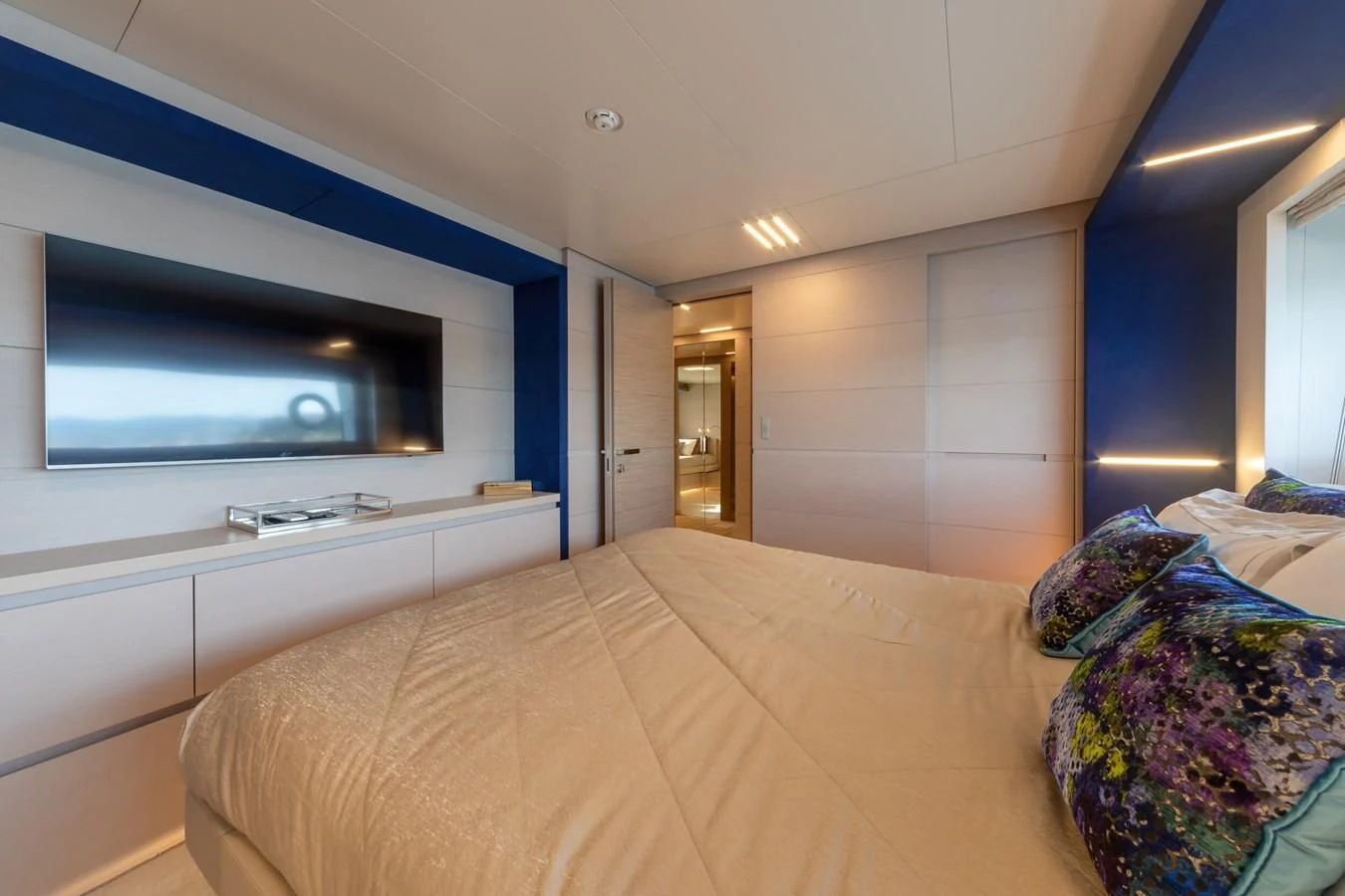 a bedroom with a bed and tv aboard FRANGELO Yacht for Sale