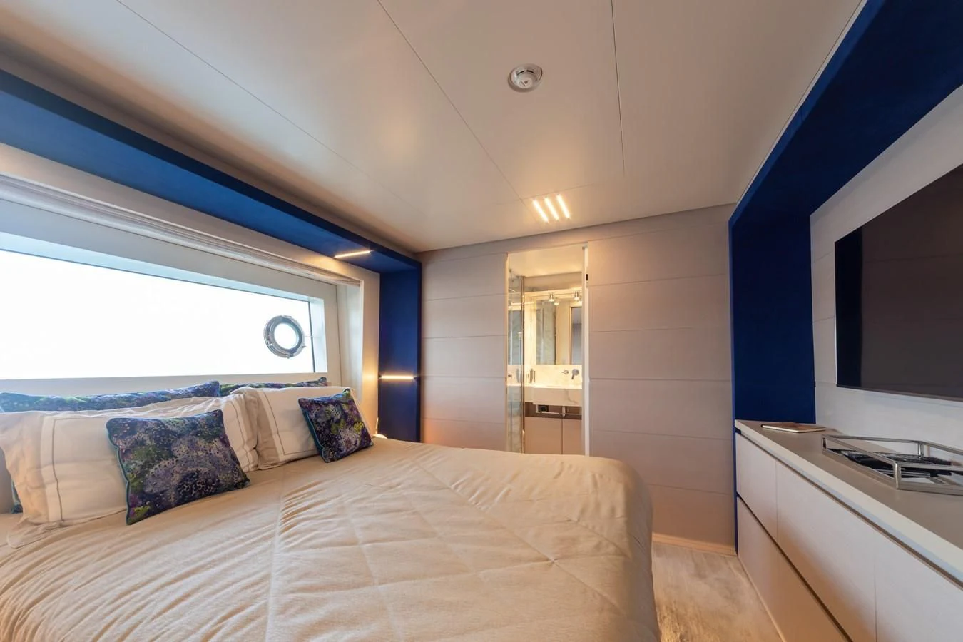 a bedroom with a bed and a window aboard FRANGELO Yacht for Sale