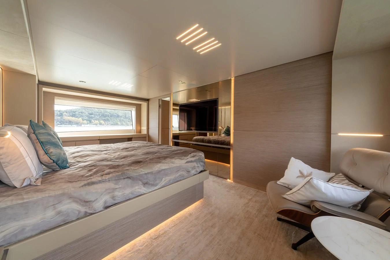 a bedroom with a bed and a couch aboard FRANGELO Yacht for Sale