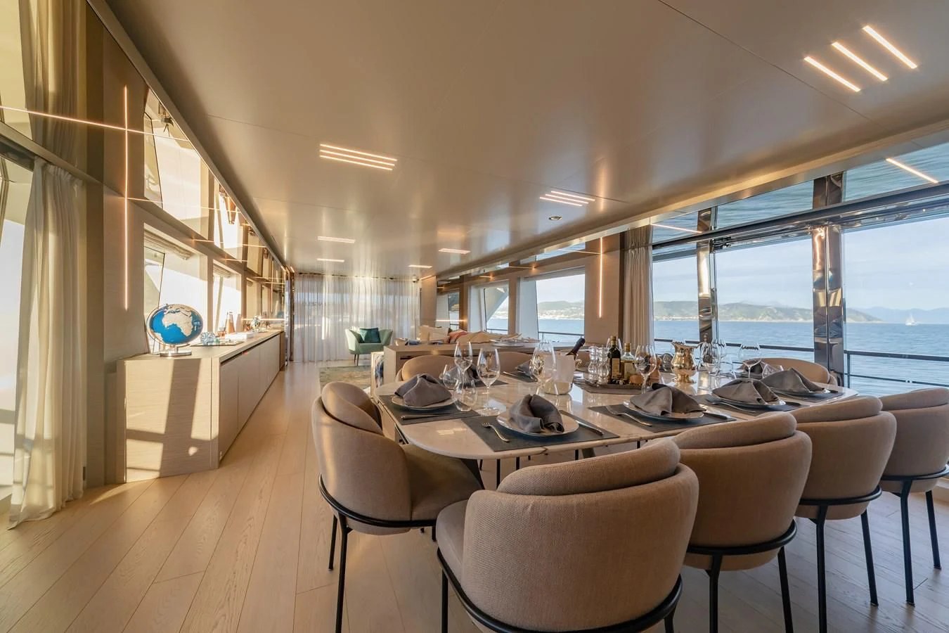 a dining room with a large window aboard FRANGELO Yacht for Sale