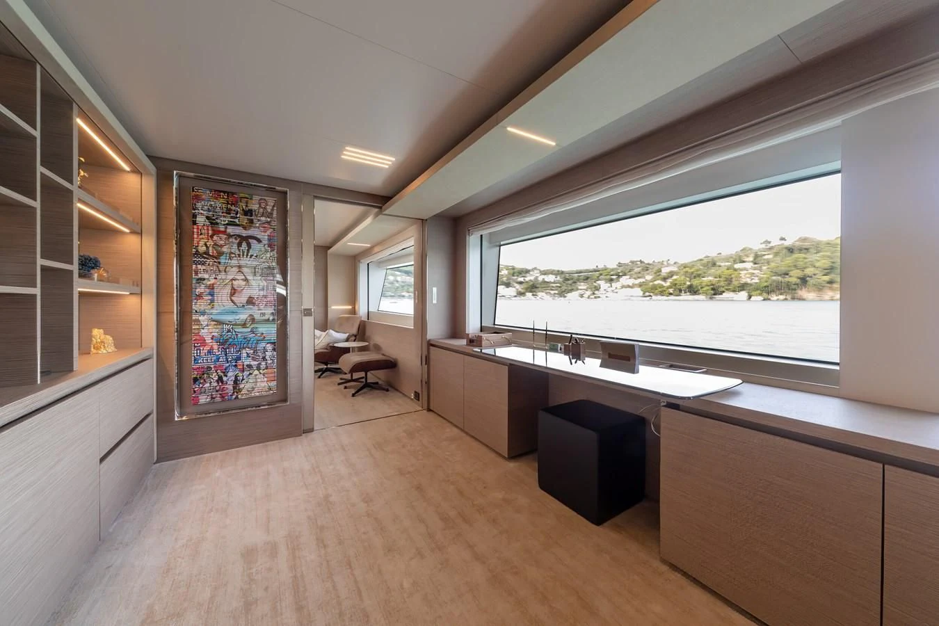 a room with a large window and a large wood desk aboard FRANGELO Yacht for Sale