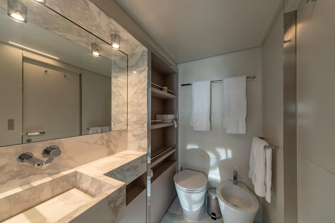 a bathroom with a mirror and a toilet aboard FRANGELO Yacht for Sale