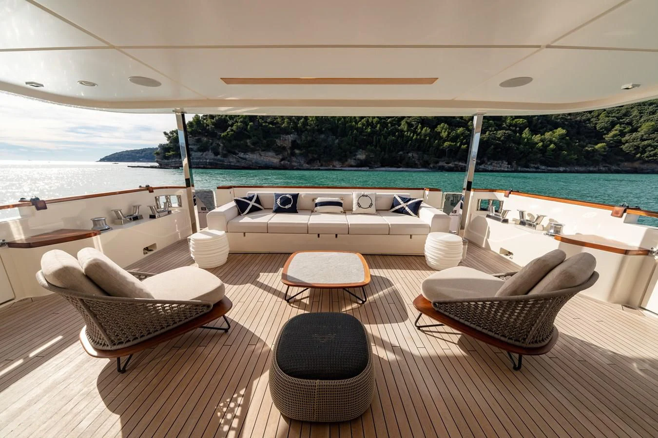 a lounge area with a lounge chair and a pool aboard FRANGELO Yacht for Sale