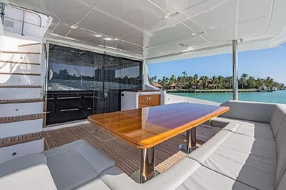 a room with a table and a pool aboard LUCKY 7 Yacht for Sale