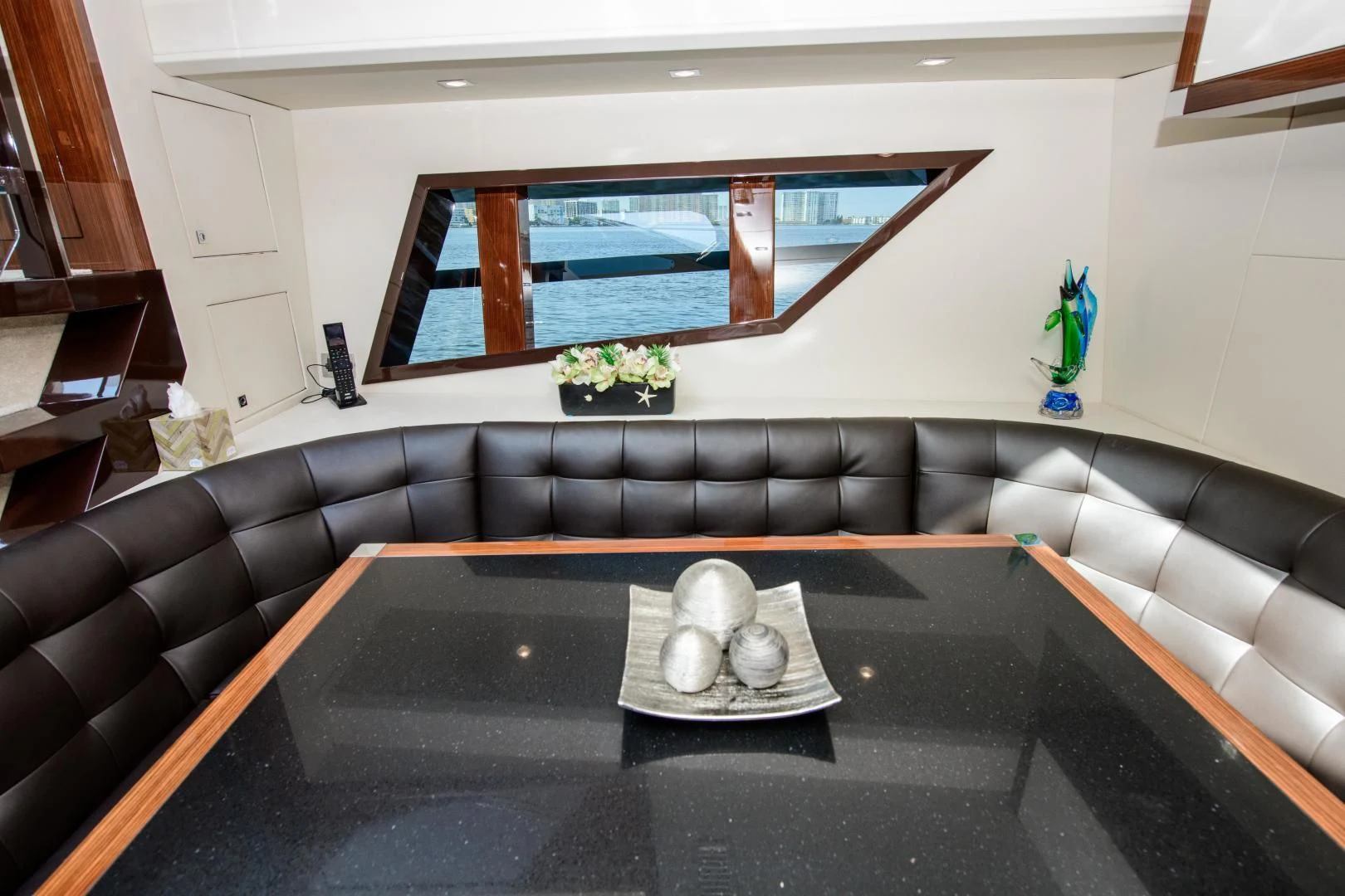 a living room with a black couch aboard CHAPTER II Yacht for Sale