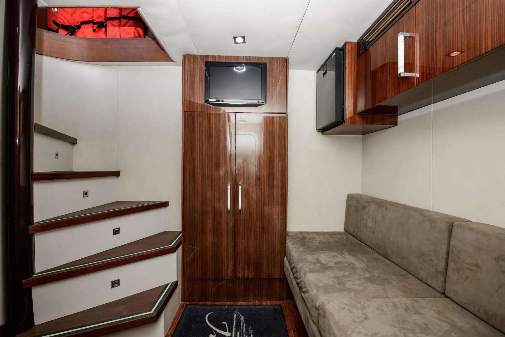 a living room with a couch and a television aboard CHAPTER II Yacht for Sale