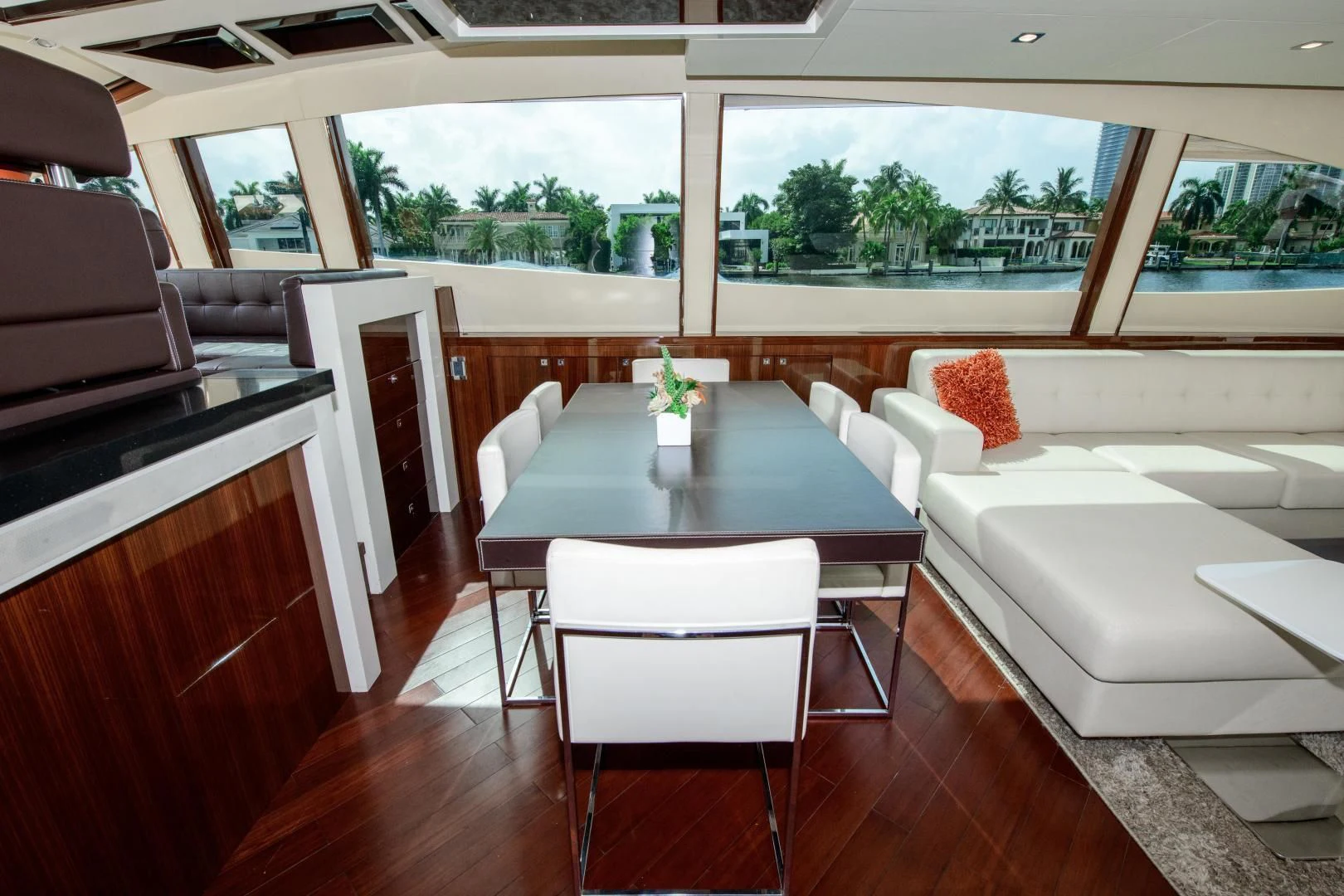 a living room with a table and couches aboard CHAPTER II Yacht for Sale