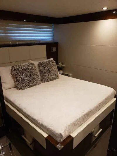 a bed with a white sheet aboard CHAPTER II Yacht for Sale