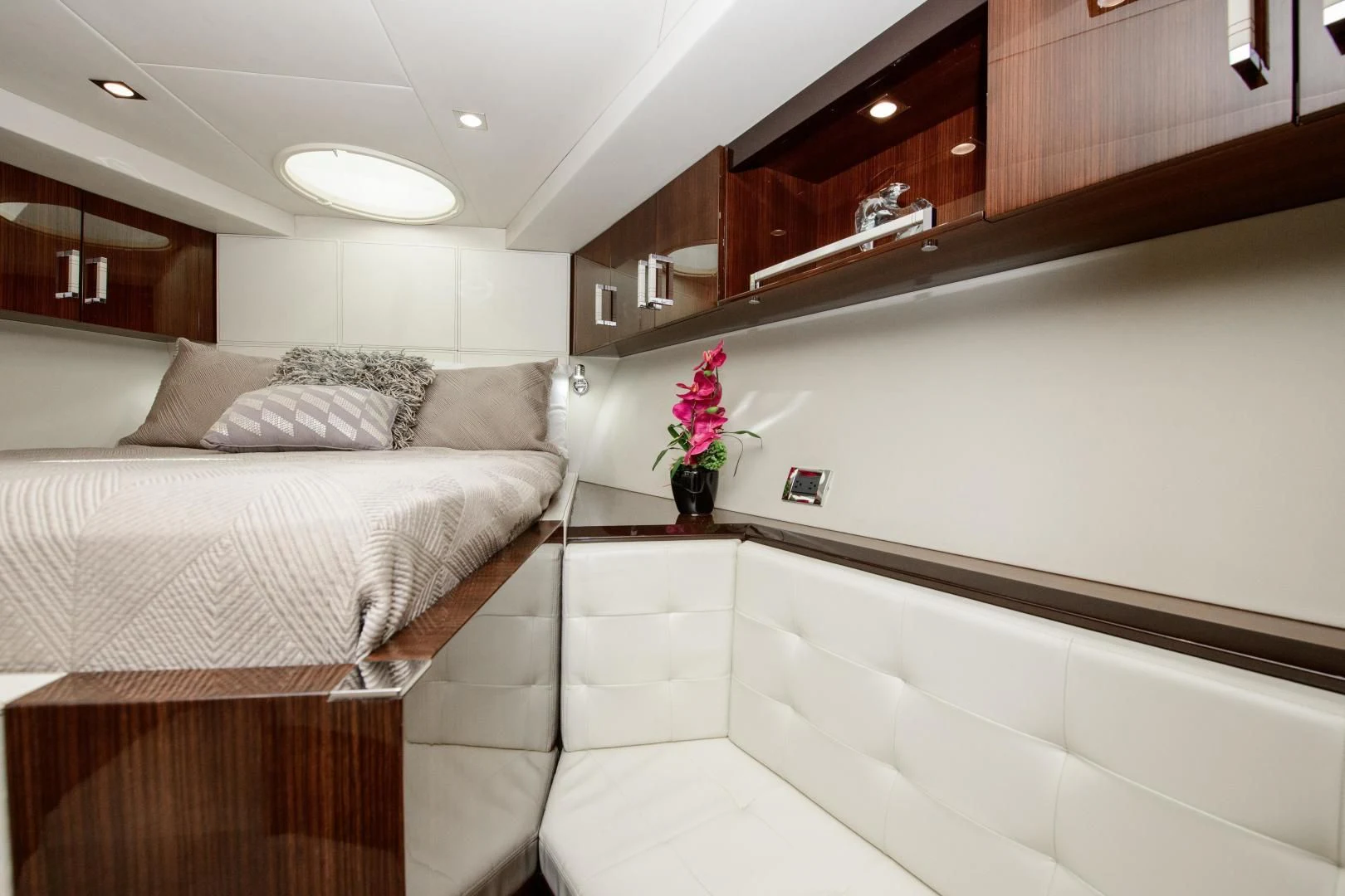 a bedroom with a bed and a dresser aboard CHAPTER II Yacht for Sale