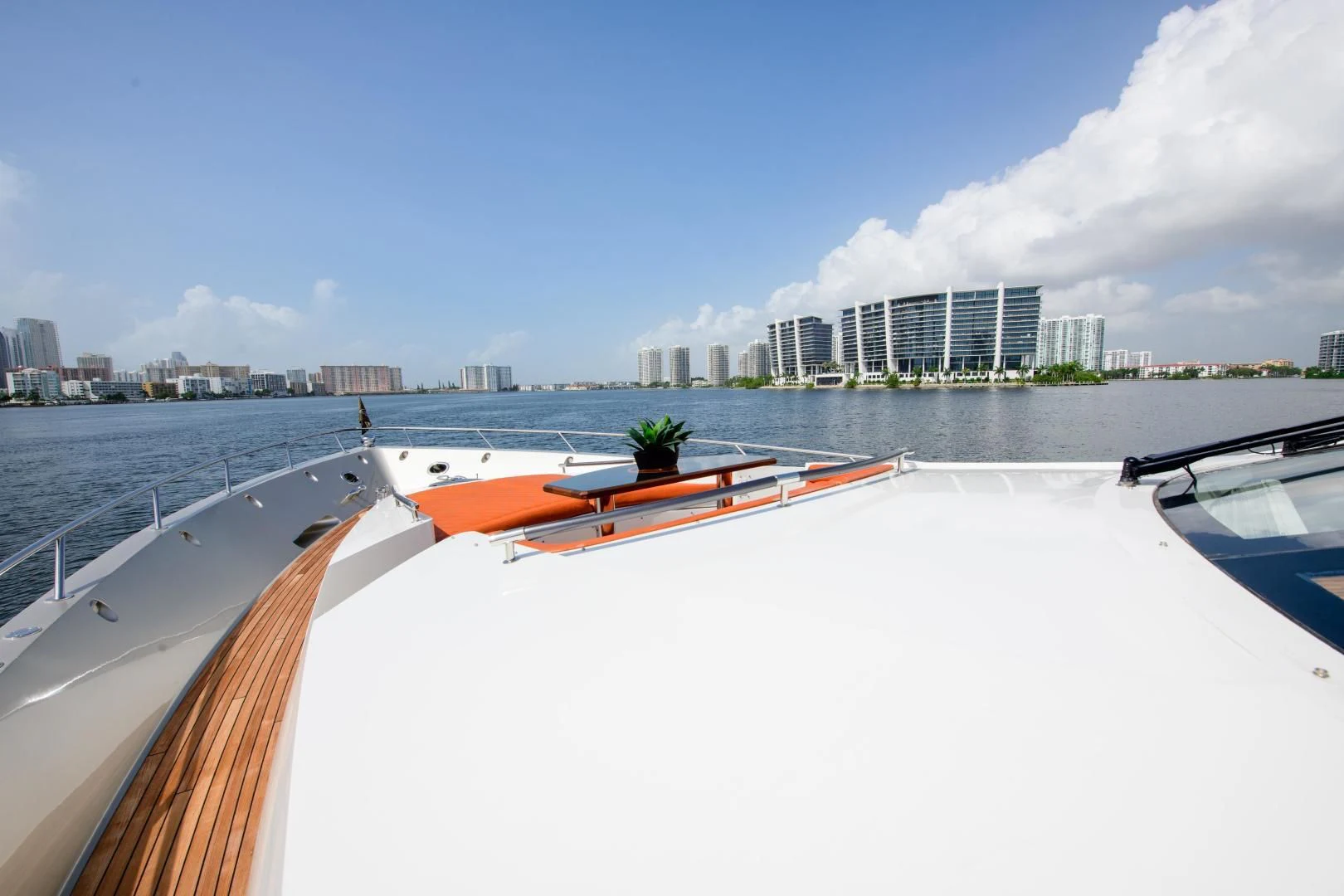 a boat on a large body of water with a city in the background aboard CHAPTER II Yacht for Sale