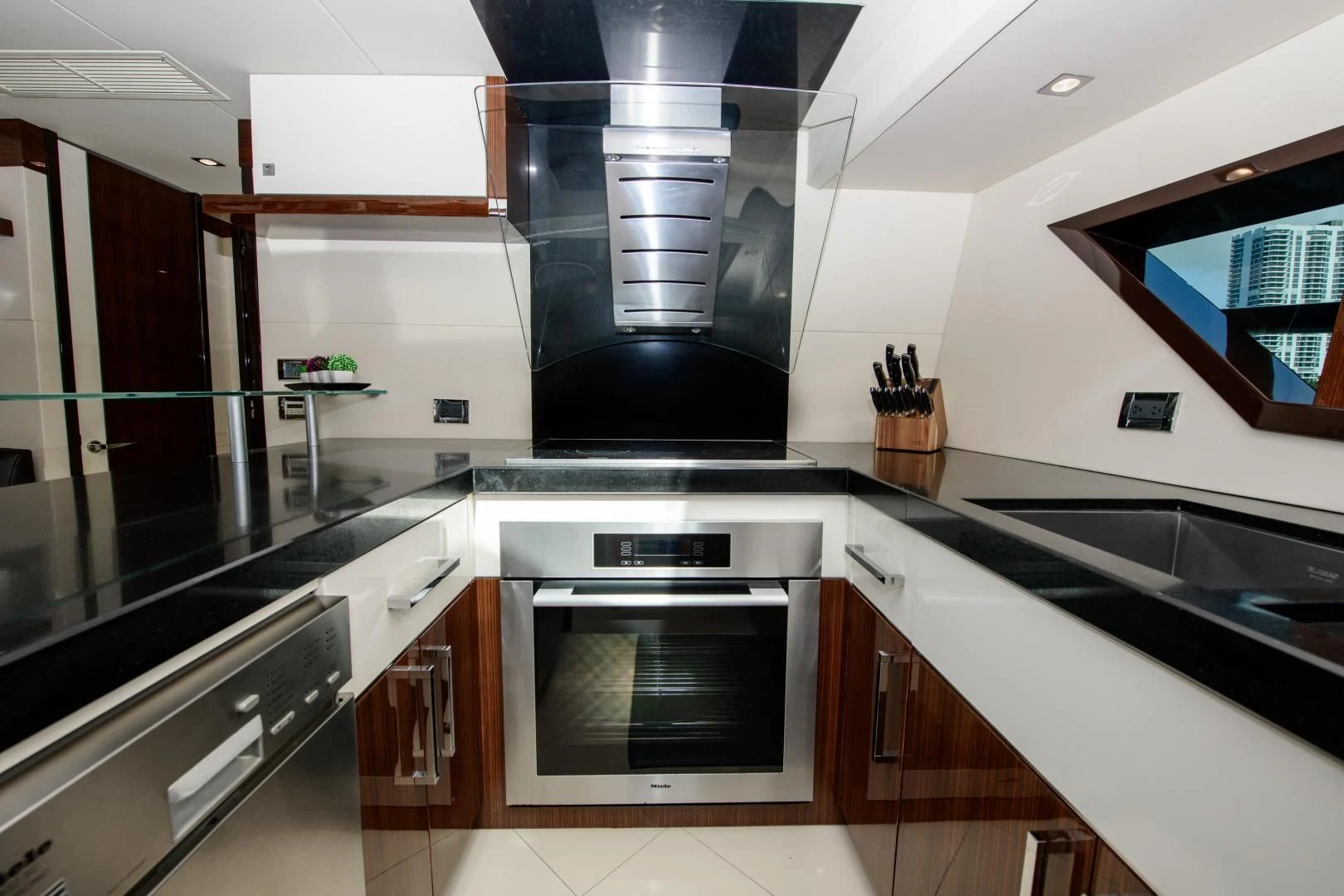 a kitchen with black and white cabinets aboard CHAPTER II Yacht for Sale