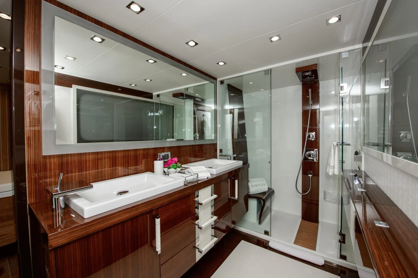 a bathroom with a large mirror aboard CHAPTER II Yacht for Sale