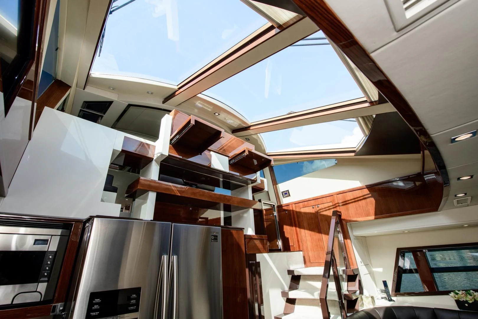 a room with a large window and a staircase aboard CHAPTER II Yacht for Sale