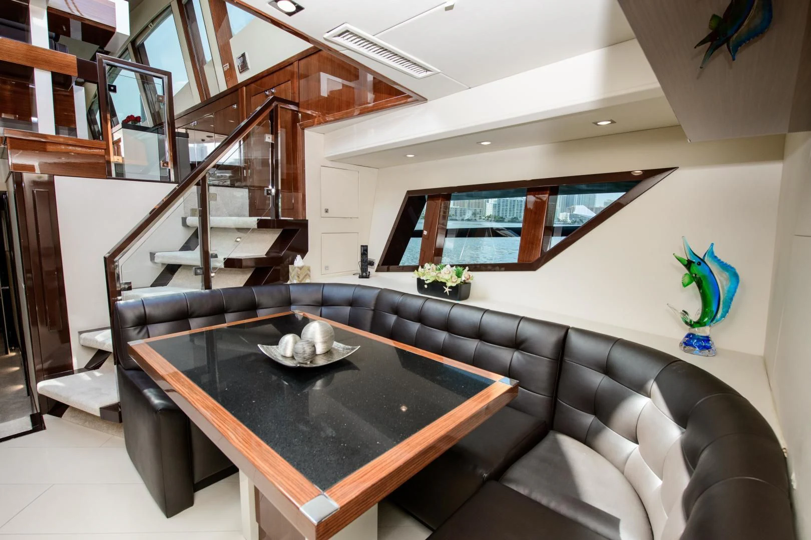 a living room with a black couch aboard CHAPTER II Yacht for Sale