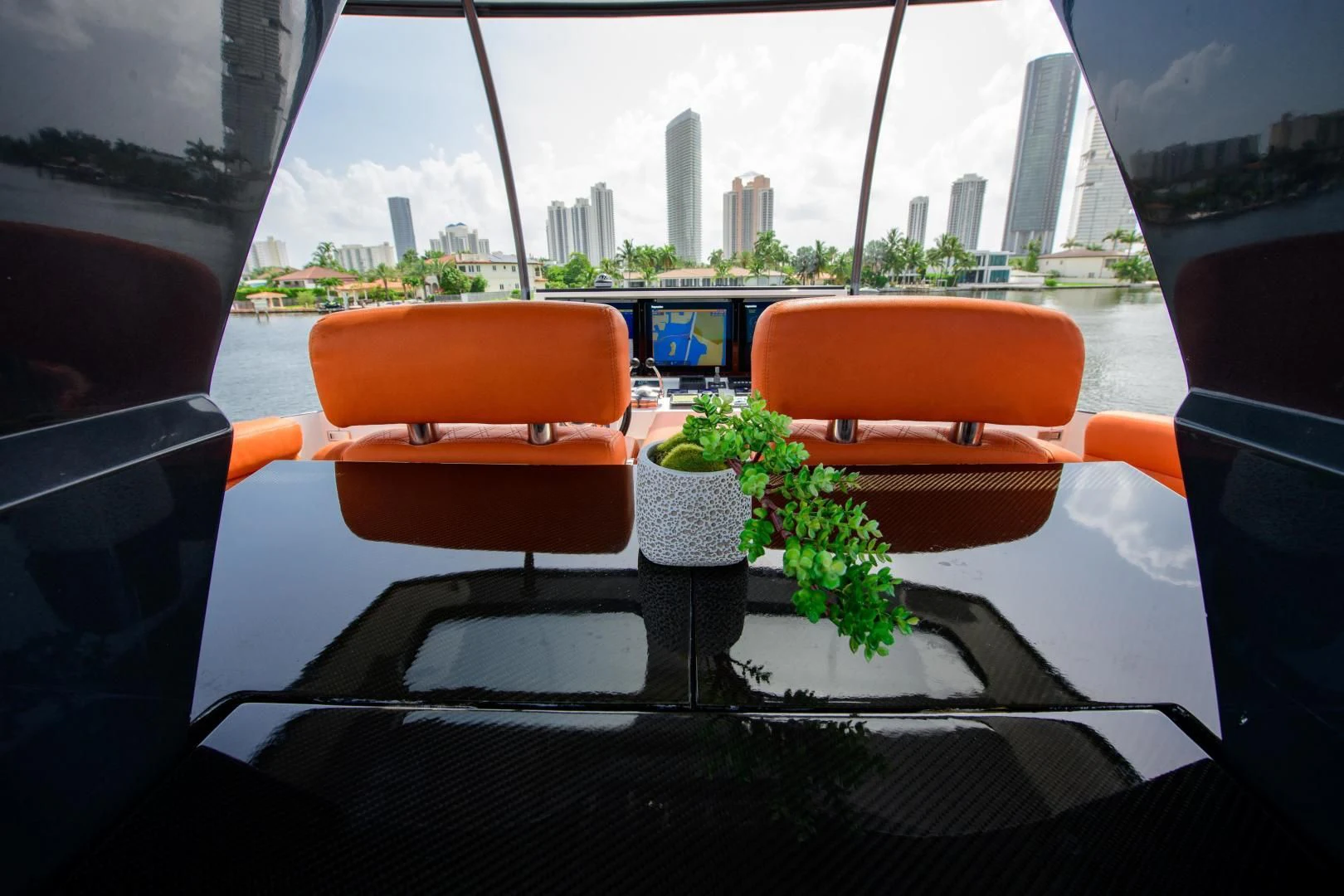 a table with chairs and plants on it aboard CHAPTER II Yacht for Sale