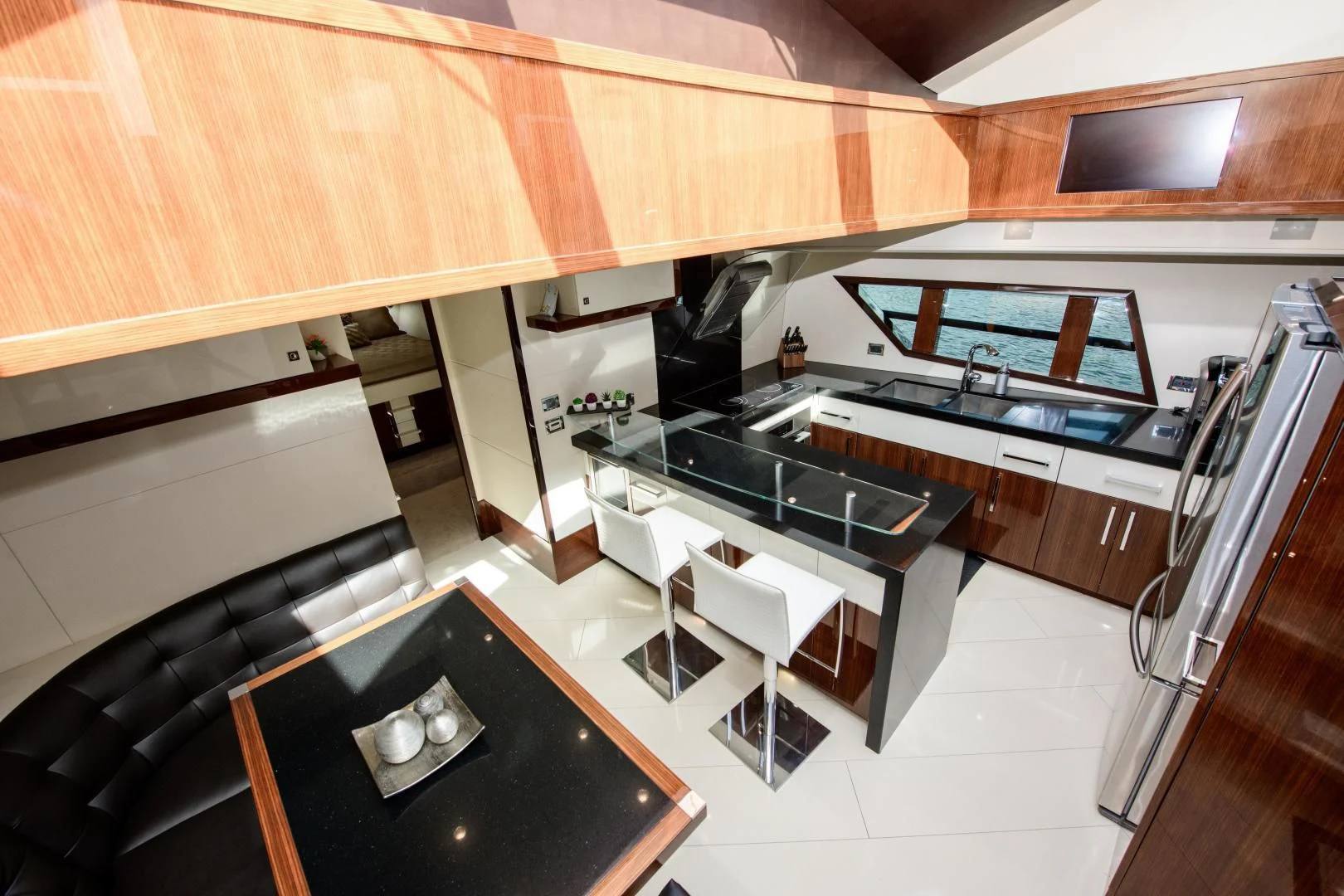 a kitchen with a black counter and black counter tops aboard CHAPTER II Yacht for Sale