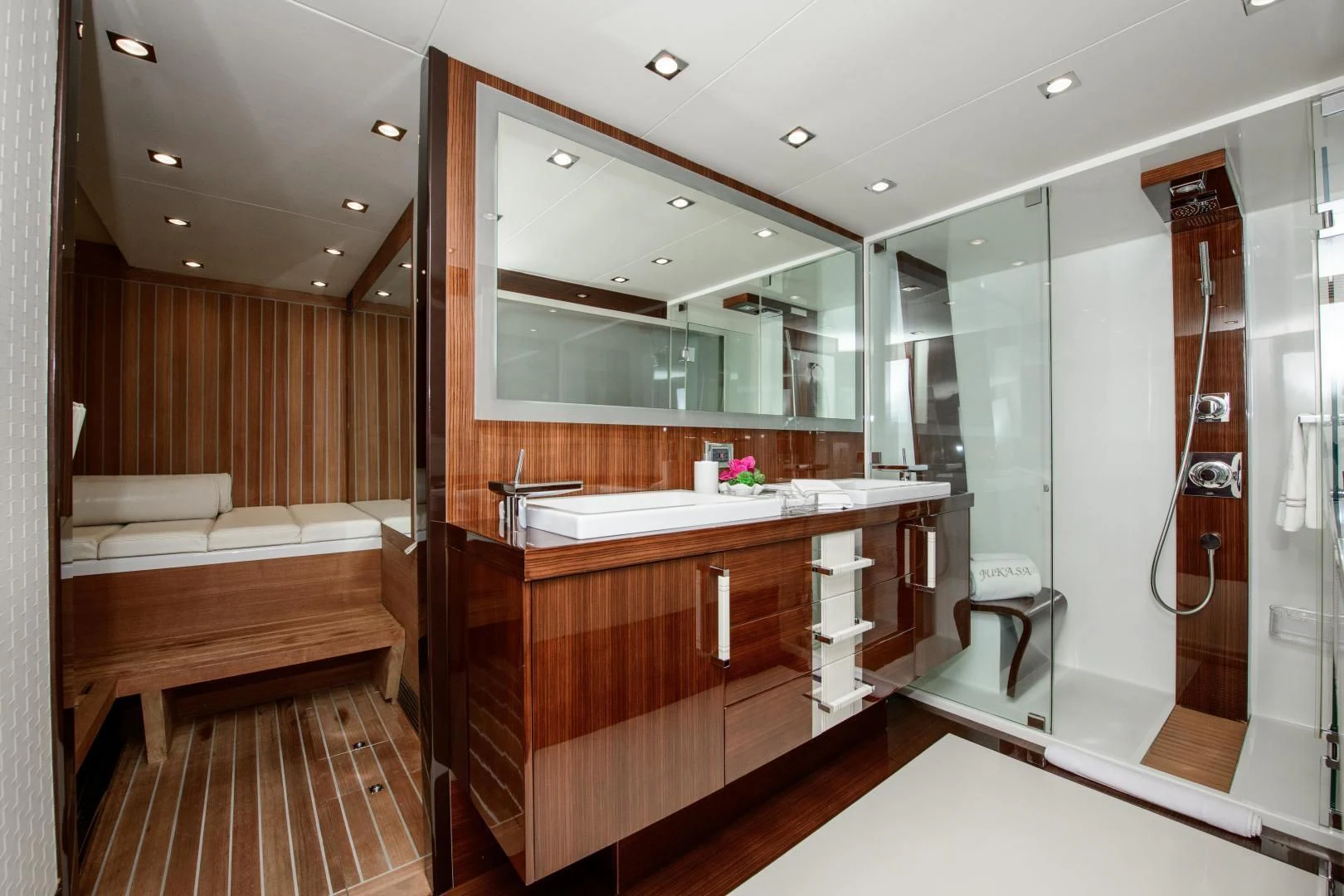 a bathroom with a large mirror aboard CHAPTER II Yacht for Sale