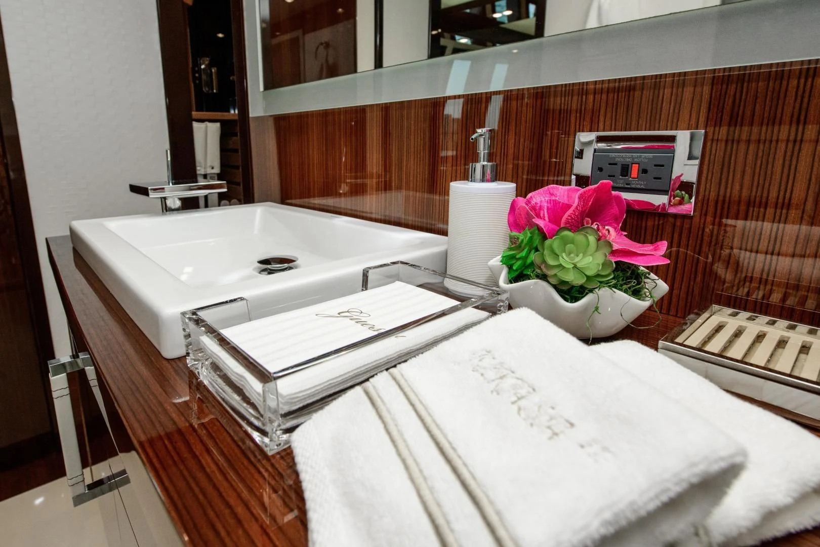 a white bathtub with a flower on it and a white towel on the side aboard CHAPTER II Yacht for Sale