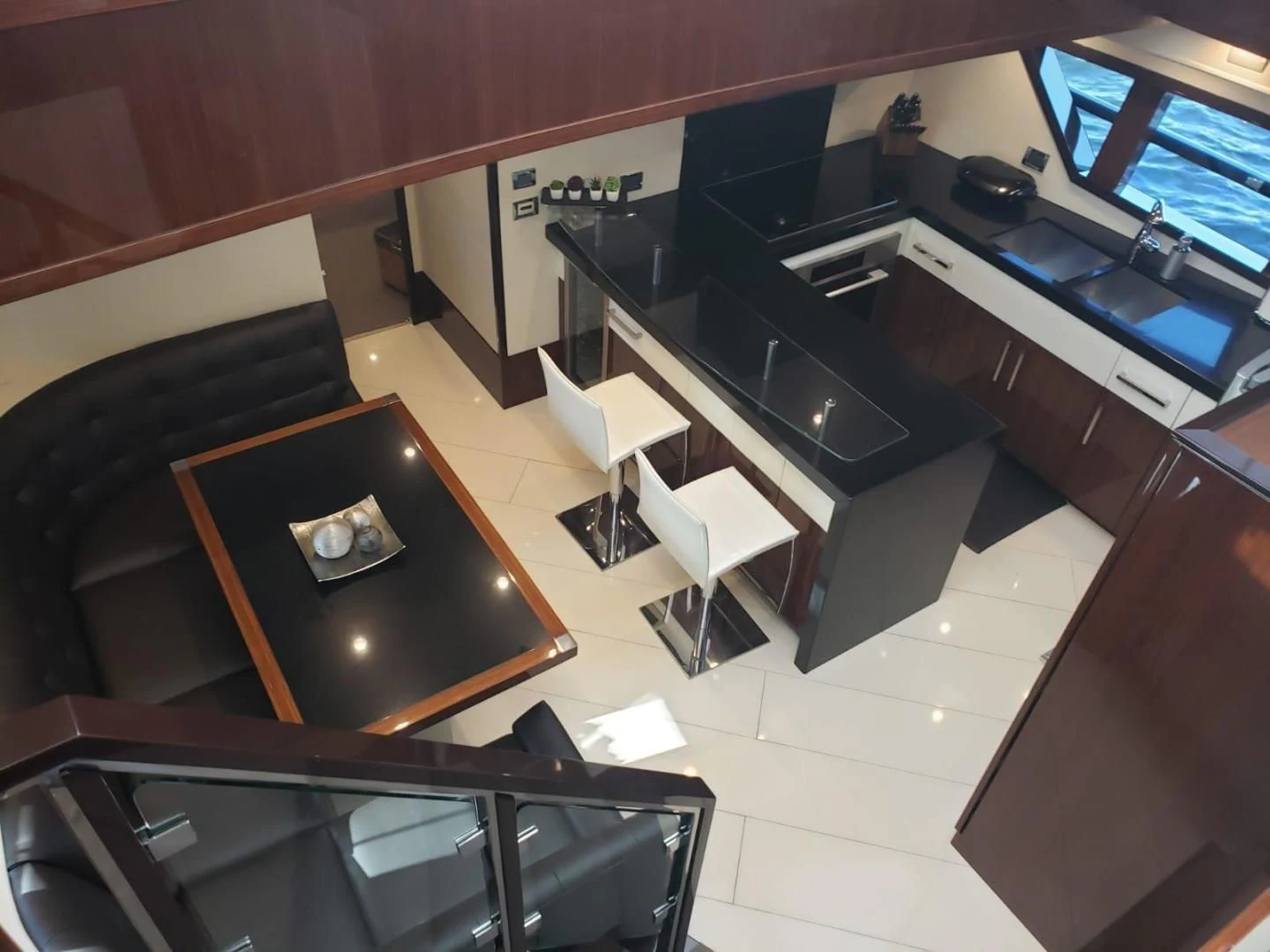 a kitchen with a bar and a table aboard CHAPTER II Yacht for Sale