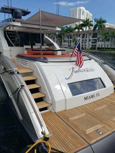 a boat with a flag on the front aboard CHAPTER II Yacht for Sale