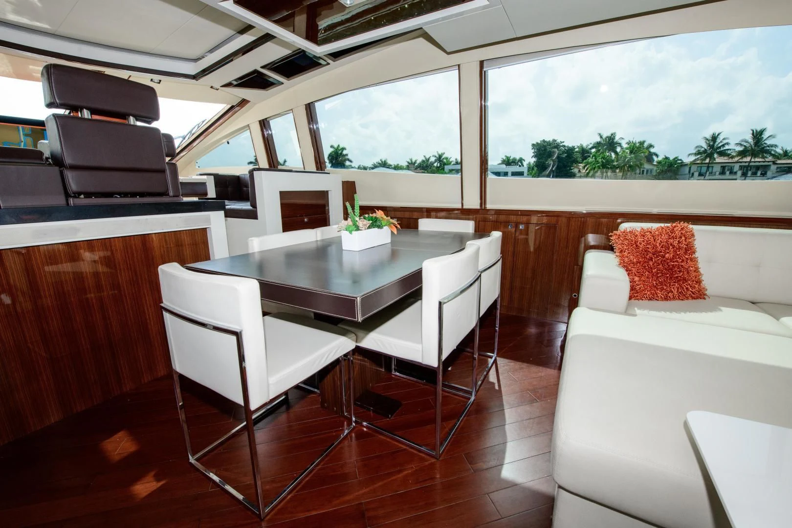 a room with a table chairs and a couch aboard CHAPTER II Yacht for Sale