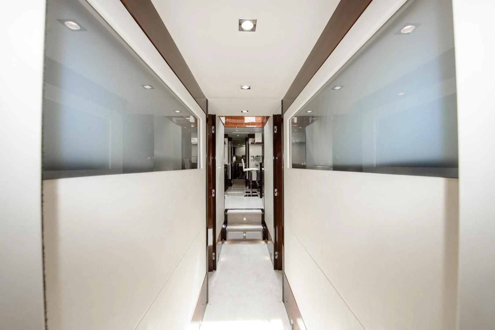 a hallway with a white wall and a staircase aboard CHAPTER II Yacht for Sale